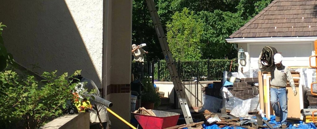 Roofing professional working during a synthetic roof installation